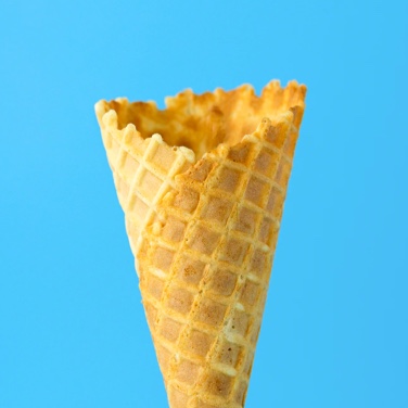 Empty icecream cone over blue background